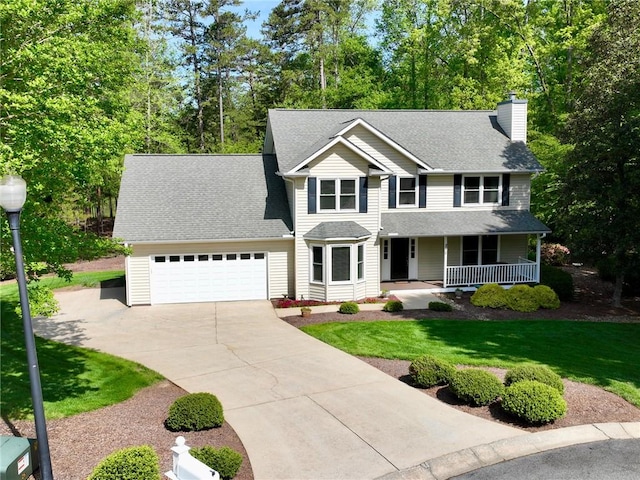 210 Wakefield Dr, Seneca, SC 29678 - view of front of property featuring concrete driveway, an attached garage, covered porch, a chimney, and a front lawn