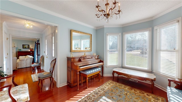 210 Wakefield Dr, Seneca, SC 29678 - living area featuring a chandelier, wood finished floors, crown molding, and a textured ceiling