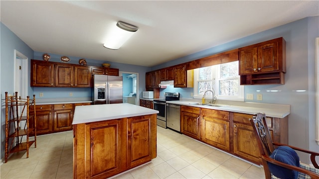 210 Wakefield Dr, Seneca, SC 29678 - kitchen with appliances with stainless steel finishes, washing machine and clothes dryer, light countertops, under cabinet range hood, and a kitchen island