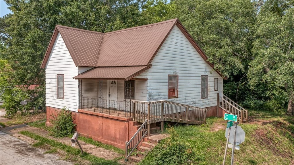200 C St, Anderson, SC 29625 - view of front of home featuring stairs, a metal roof, and view of scattered trees