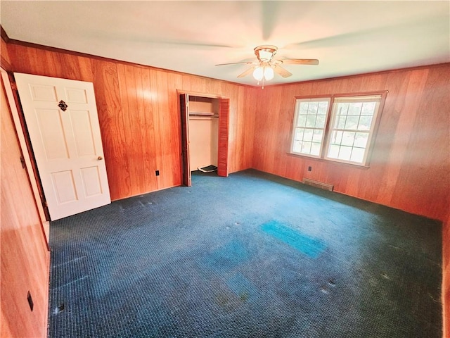 150 Prater Dr, Seneca, SC 29678 - unfurnished bedroom featuring wooden walls, carpet, a closet, and ceiling fan
