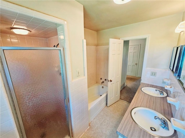 150 Prater Dr, Seneca, SC 29678 - bathroom featuring a stall shower, double vanity, a garden tub, tile walls, and a wainscoted wall