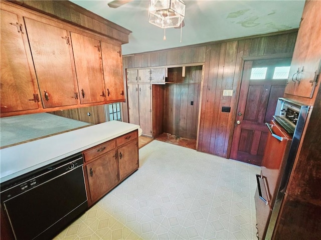 150 Prater Dr, Seneca, SC 29678 - kitchen featuring dishwasher, ceiling fan, light countertops, wooden walls, and brown cabinets