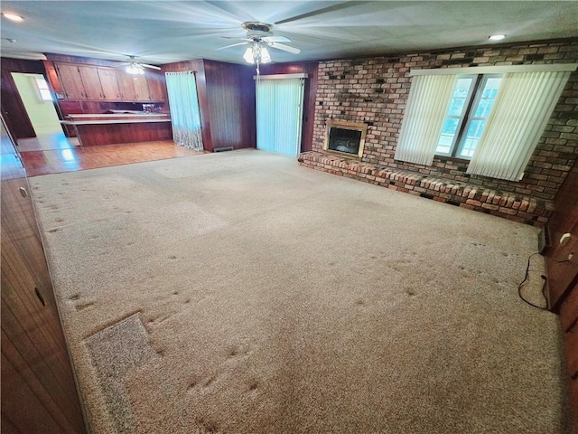 150 Prater Dr, Seneca, SC 29678 - unfurnished living room with plenty of natural light, ceiling fan, a brick fireplace, and carpet