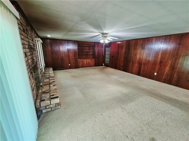 150 Prater Dr, Seneca, SC 29678 - unfurnished room featuring carpet flooring, wooden walls, ceiling fan, and a brick fireplace