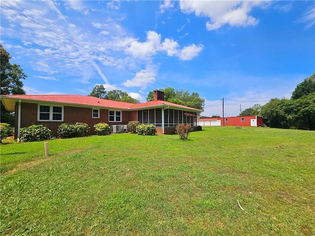 150 Prater Dr, Seneca, SC 29678 - back of house featuring a sunroom, a lawn, a chimney, a metal roof, and brick siding