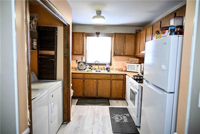 343 Old Greenville Hwy Unit 5, Clemson, SC 29631 - kitchen featuring white appliances, washer and clothes dryer, brown cabinetry, light countertops, and light wood-style floors