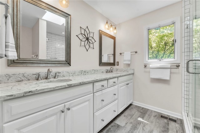 4 Slack Tide Ct, Salem, SC 29676 - bathroom featuring double vanity, a tile shower, and wood finished floors