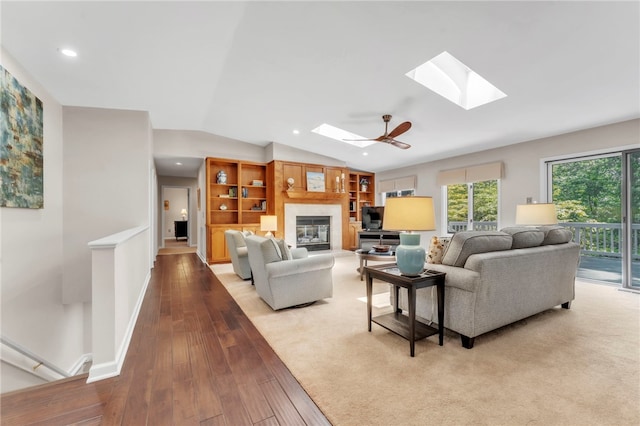 4 Slack Tide Ct, Salem, SC 29676 - living area with a skylight, a glass covered fireplace, wood-type flooring, lofted ceiling, and recessed lighting