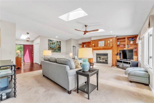 4 Slack Tide Ct, Salem, SC 29676 - living area with a skylight, a glass covered fireplace, vaulted ceiling, carpet, and a ceiling fan