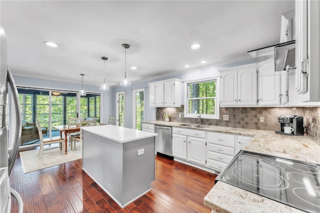 4 Slack Tide Ct, Salem, SC 29676 - kitchen featuring stainless steel appliances, crown molding, a center island, white cabinetry, and decorative backsplash