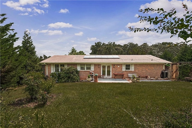 4 Grandview Rd, Travelers Rest, SC 29690 - rear view of house featuring roof mounted solar panels, a patio area, and brick siding