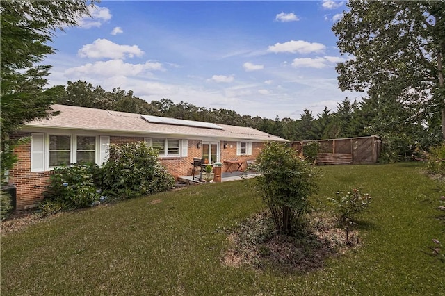 4 Grandview Rd, Travelers Rest, SC 29690 - rear view of property featuring brick siding, roof mounted solar panels, a lawn, and a patio area