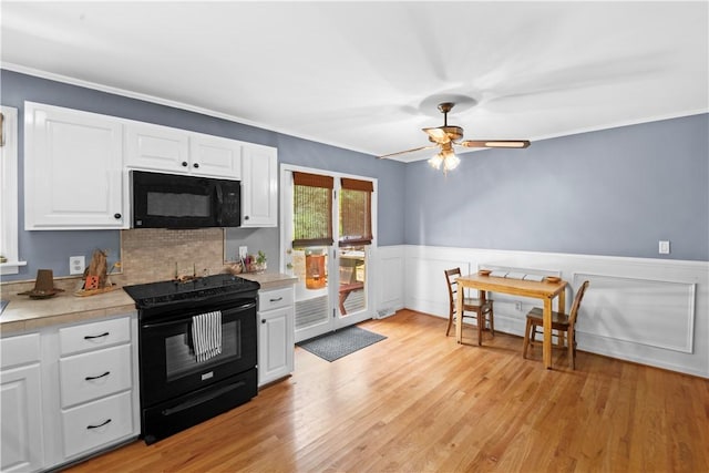 4 Grandview Rd, Travelers Rest, SC 29690 - kitchen featuring black appliances, light countertops, white cabinets, ceiling fan, and a wainscoted wall