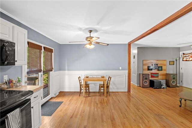 4 Grandview Rd, Travelers Rest, SC 29690 - kitchen featuring black appliances, ceiling fan, white cabinetry, light wood-type flooring, and wainscoting