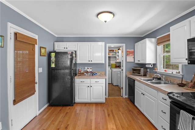 4 Grandview Rd, Travelers Rest, SC 29690 - kitchen with black appliances, washer and dryer, white cabinetry, light wood-type flooring, and ornamental molding