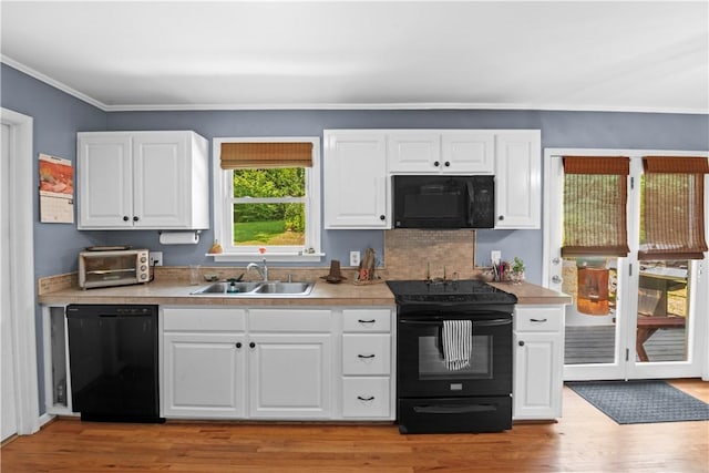4 Grandview Rd, Travelers Rest, SC 29690 - kitchen featuring black appliances, light countertops, ornamental molding, white cabinets, and light wood finished floors