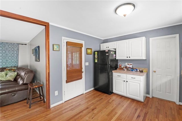 4 Grandview Rd, Travelers Rest, SC 29690 - kitchen featuring freestanding refrigerator, open floor plan, white cabinetry, light wood finished floors, and crown molding