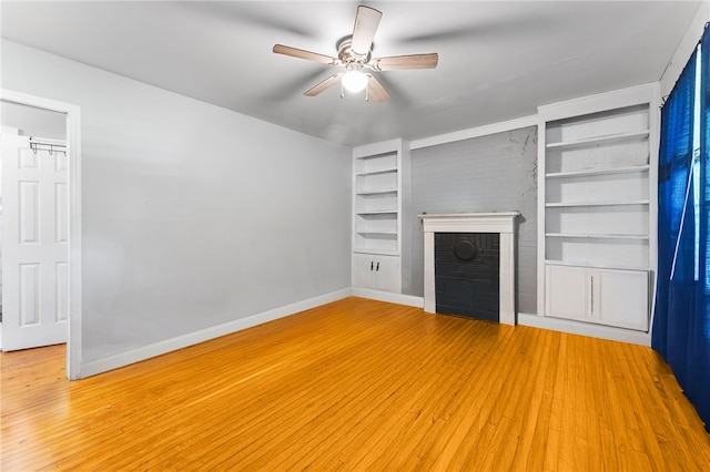 805 Cooley Bridge Rd, Pelzer, SC 29669 - unfurnished living room featuring built in features, a brick fireplace, ceiling fan, and light wood-type flooring