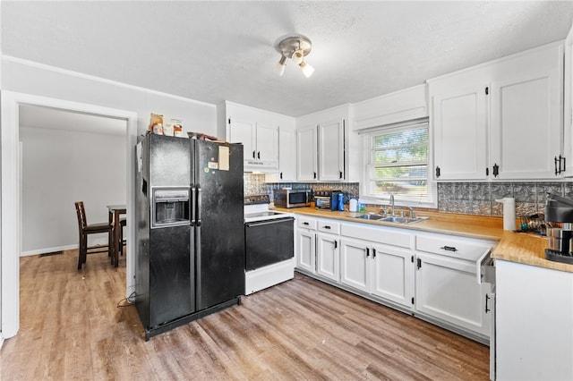 805 Cooley Bridge Rd, Pelzer, SC 29669 - kitchen featuring white electric range, black fridge, stainless steel microwave, under cabinet range hood, and backsplash