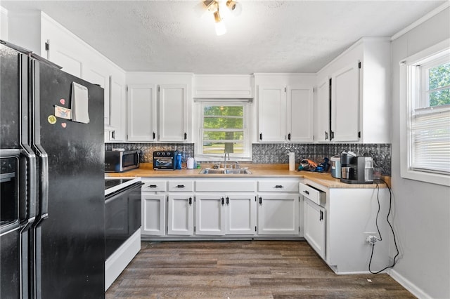 805 Cooley Bridge Rd, Pelzer, SC 29669 - kitchen featuring black refrigerator with ice dispenser, white range with electric stovetop, stainless steel microwave, dark wood-type flooring, and light countertops