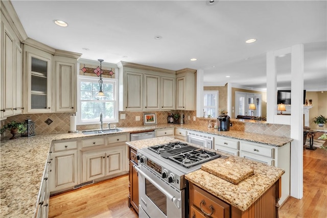 105 Wren Crossing Ct, Easley, SC 29642 - kitchen featuring appliances with stainless steel finishes, cream cabinetry, healthy amount of natural light, ornamental molding, and recessed lighting