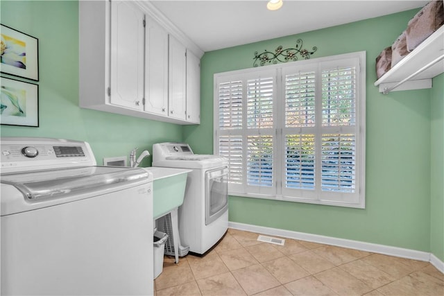 105 Wren Crossing Ct, Easley, SC 29642 - laundry room with washing machine and clothes dryer, cabinet space, and light tile patterned flooring