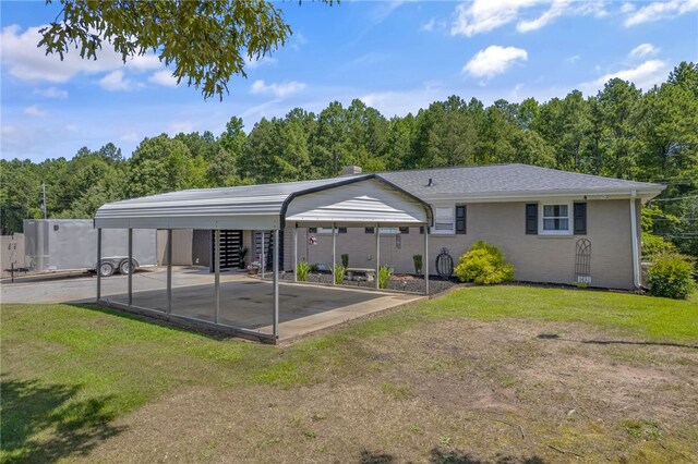 701 Durham Brown Rd, Seneca, SC 29678 - rear view of property featuring a detached carport, a yard, and a wooded view