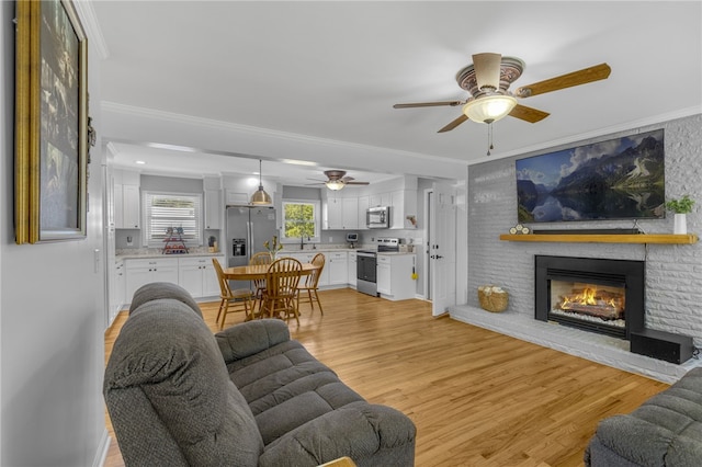 701 Durham Brown Rd, Seneca, SC 29678 - living area with a ceiling fan, crown molding, light wood finished floors, and a fireplace