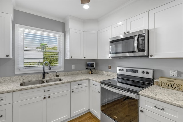 701 Durham Brown Rd, Seneca, SC 29678 - kitchen featuring stainless steel appliances, white cabinetry, crown molding, and light stone countertops