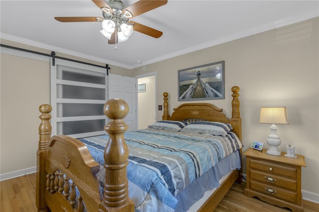 701 Durham Brown Rd, Seneca, SC 29678 - bedroom featuring wood finished floors, a barn door, crown molding, and a ceiling fan