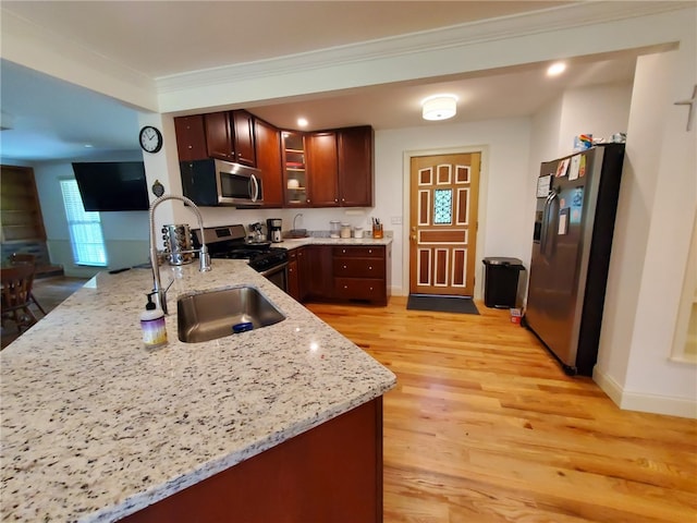 412 Bishop Branch Rd, Pendleton, SC 29670 - kitchen featuring stainless steel appliances, light wood-style floors, ornamental molding, light stone counters, and glass insert cabinets