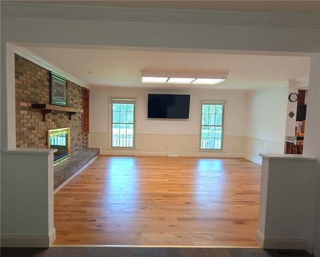 412 Bishop Branch Rd, Pendleton, SC 29670 - unfurnished living room featuring wood finished floors, a fireplace, and crown molding