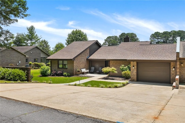 122 Downs Blvd, Clemson, SC 29631 - view of front of property with driveway, brick siding, an attached garage, a front yard, and roof with shingles