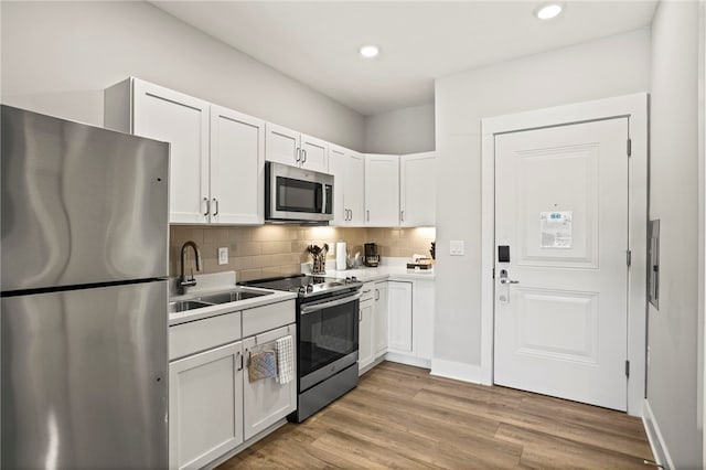 13500 Clemson Blvd Unit 2225A, Seneca, SC 29678 - kitchen featuring stainless steel appliances, white cabinets, tasteful backsplash, light wood-type flooring, and light countertops