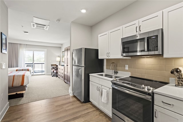 13500 Clemson Blvd Unit 2225A, Seneca, SC 29678 - kitchen with appliances with stainless steel finishes, white cabinetry, open floor plan, backsplash, and light countertops