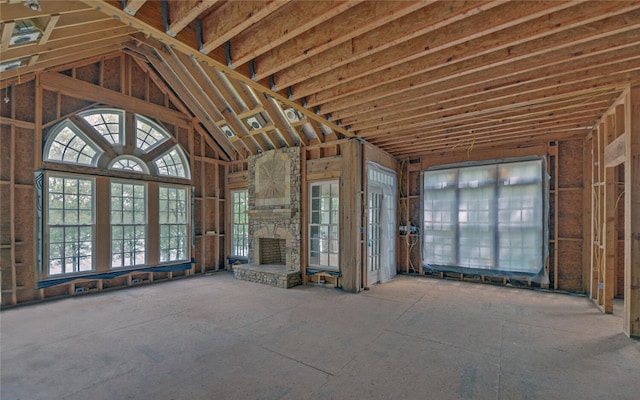 210 Rosewood Cir, Hartwell, GA 30643 - unfurnished living room featuring a stone fireplace and lofted ceiling