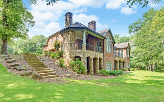 210 Rosewood Cir, Hartwell, GA 30643 - back of property featuring a chimney, stone siding, a balcony, stairway, and a lawn