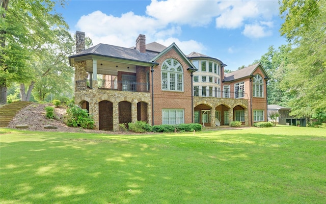210 Rosewood Cir, Hartwell, GA 30643 - rear view of house with a balcony, a chimney, a lawn, and stone siding