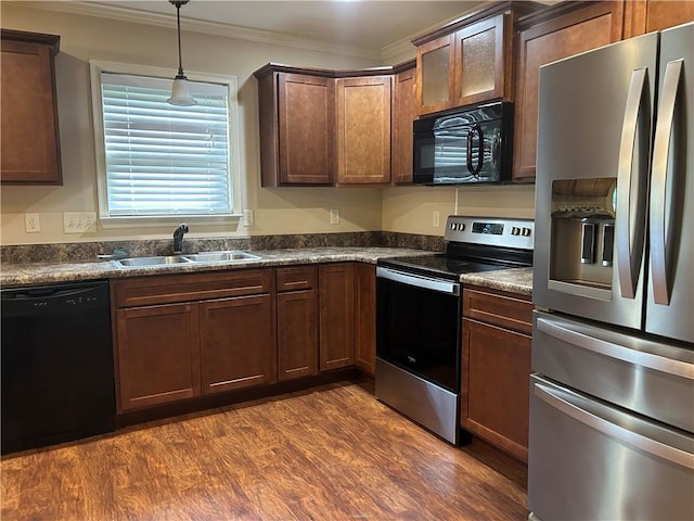1016 Sand Palm Way, Anderson, SC 29621 - kitchen with black appliances, dark countertops, ornamental molding, dark wood finished floors, and pendant lighting