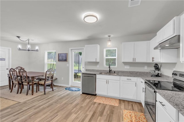 117 Enchanted Walk, Pickens, SC 29671 - kitchen with stainless steel appliances, under cabinet range hood, light wood finished floors, white cabinetry, and a chandelier