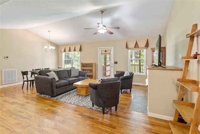 518 Pecan Grove Rd, Seneca, SC 29672 - living area featuring vaulted ceiling, wood finished floors, a chandelier, plenty of natural light, and a ceiling fan