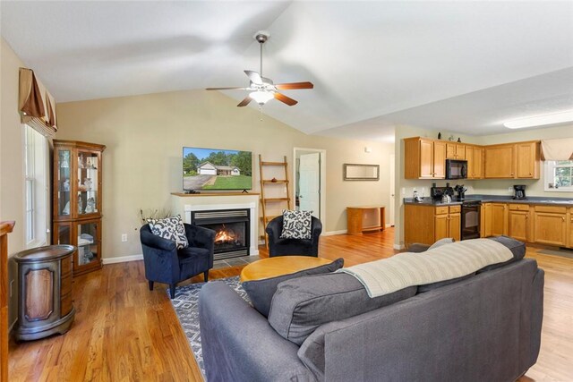 518 Pecan Grove Rd, Seneca, SC 29672 - living room with a fireplace with flush hearth, light wood-type flooring, vaulted ceiling, and ceiling fan