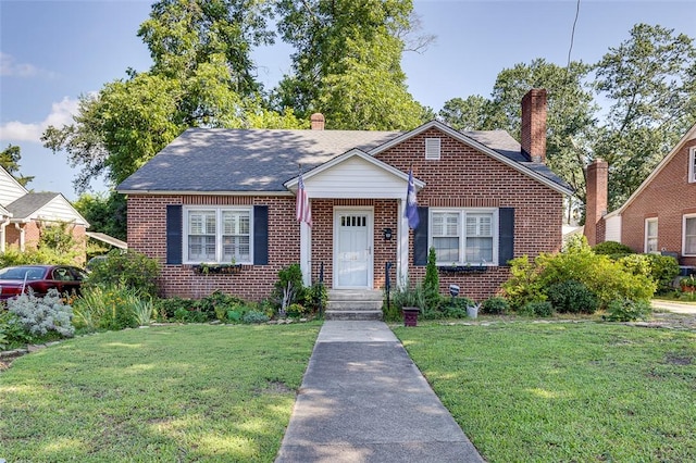 118 Glenwood Ave, Anderson, SC 29625 - bungalow featuring brick siding, a front lawn, and a chimney
