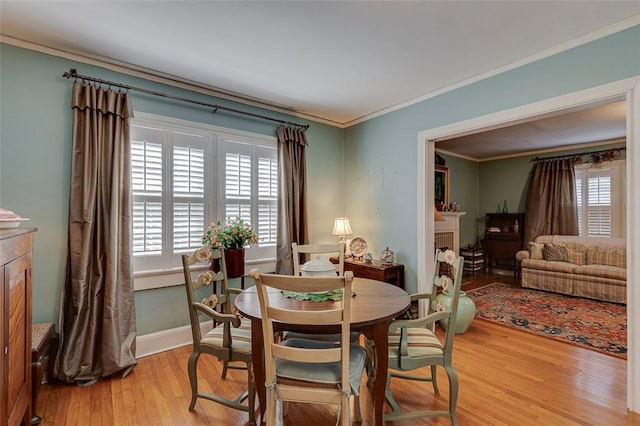 118 Glenwood Ave, Anderson, SC 29625 - dining space with light wood-style floors, a fireplace, and ornamental molding