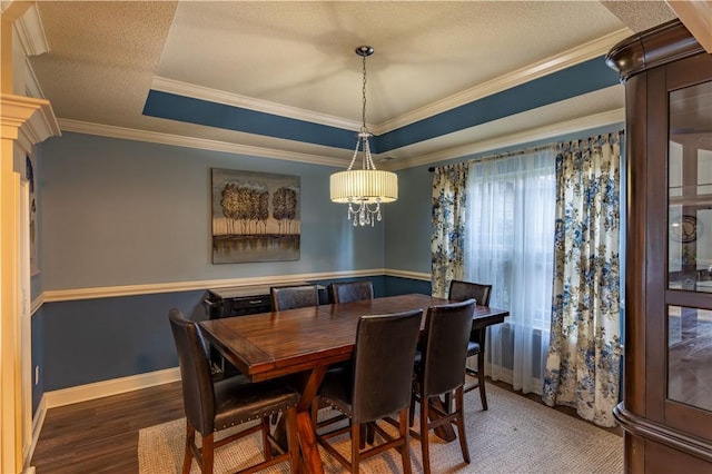 2444 Poole Rd, Greer, SC 29650 - dining space featuring wood finished floors, ornamental molding, a tray ceiling, and a textured ceiling