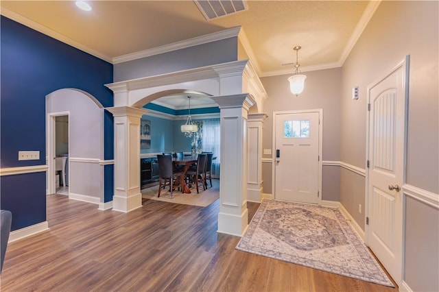 2444 Poole Rd, Greer, SC 29650 - foyer entrance with decorative columns, arched walkways, wood finished floors, and crown molding