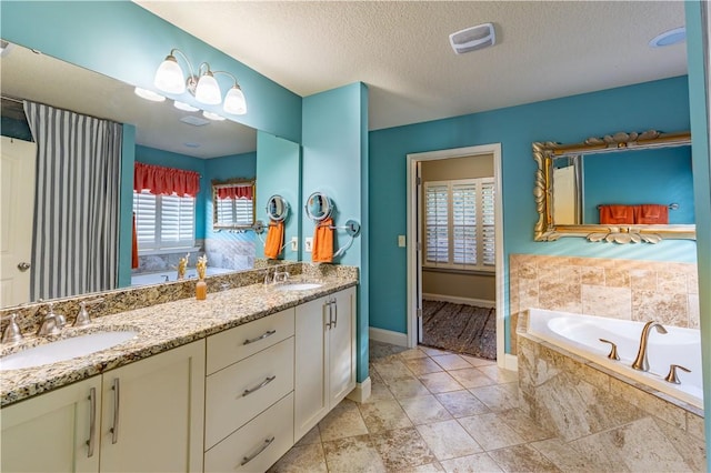 2444 Poole Rd, Greer, SC 29650 - bathroom featuring double vanity, a textured ceiling, and a bath