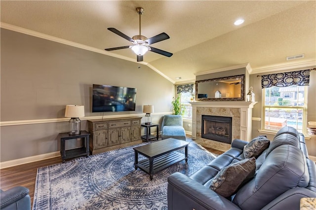 2444 Poole Rd, Greer, SC 29650 - living room with wood finished floors, a tiled fireplace, ornamental molding, a ceiling fan, and lofted ceiling