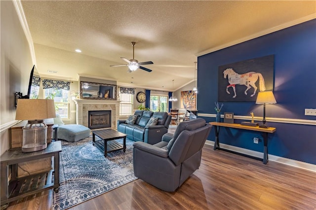 2444 Poole Rd, Greer, SC 29650 - living area featuring crown molding, a textured ceiling, wood finished floors, plenty of natural light, and a tiled fireplace